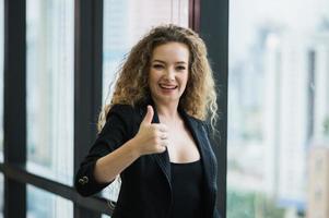 Young beautiful business woman showing thumbs up.