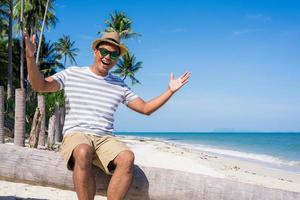 Happy Young man on the tropical beach photo