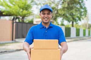 Deliver man in blue uniform and parcel cardboard box