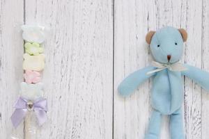White painted wood table blue bear doll cotton candy photo
