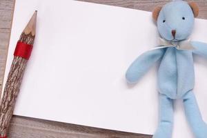 Wooden pencil blank sketch white paper blue bear doll photo