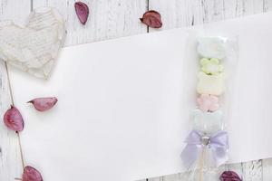 Paper with candy and petals photo