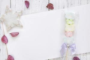 Paper with candy, petals, and star photo