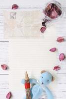 Paper with petals, pencil, and toy photo