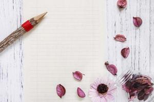 Paper with petals and pencil photo