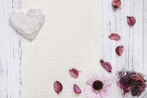 Flower, petals and heart on paper photo