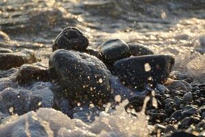 Natural background with large stones and waves photo