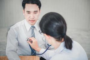Medical Doctor is Examining Patient Health With Stethoscope photo