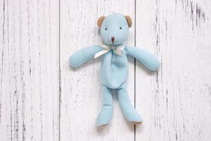 Blue bear on white wood photo