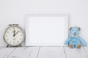 White frame with clock and bear photo