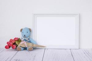 White frame with bear and flowers photo