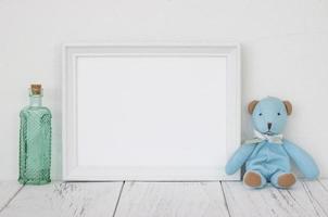 White frame with bottle and bear photo