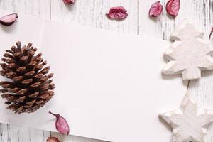 Paper with pinecone and ornaments photo