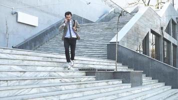 Young male businessman with backpack run on the stairs video
