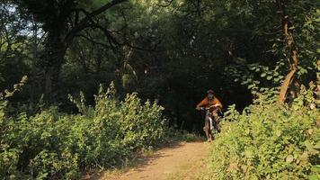 Young male on bicycle with helmet ride alone in the forest