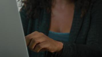 Woman uses laptop and talks to person sitting next to her video