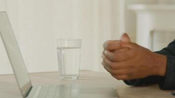 Woman and man having conversation sitting at table with laptop video