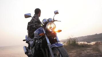 male traveler with bike on the beach video