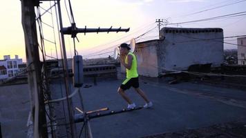 Young male boxer or karate fighter training on the roof video