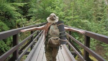 Young woman hiker travel alone in the forest