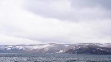 Winter snow mountain baikal lake landscape view in Listvyanka Russia photo