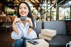 smile woman holding credit card photo