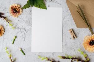 A blank card with envelope and flower is placed on white background photo