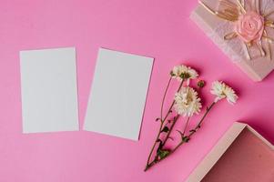 pink gift box, flower and blank card on pink background photo