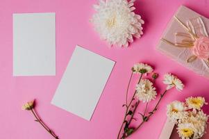 pink gift box, flower and blank card on pink background photo