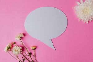 speech bubble oval, flower and clear card with pink background photo