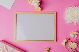 white board with flower on pink background photo