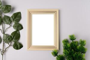 white photo frame and leaf branches on white background