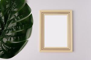 white photo frame and leaf on white background