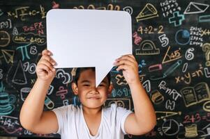 Child acting with speech bubble in the classroom photo