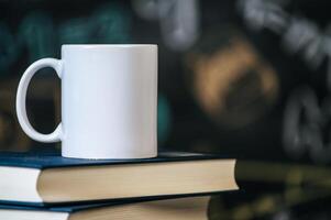 cup on the books in classroom photo