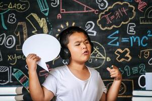 Child acting with speech bubble in the classroom photo