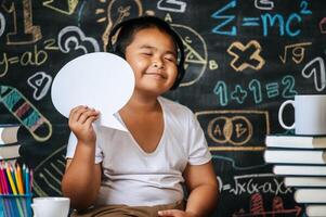 Child acting with speech bubble in the classroom photo