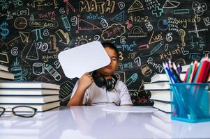 Child acting with speech bubble in the classroom photo