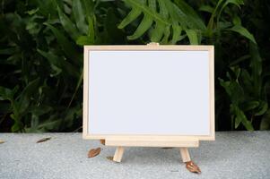 The picture frame is placed on the cement table. photo