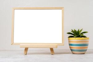 Standing picture frame with small potted plants photo