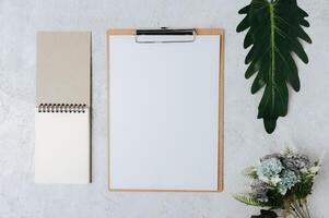 Note paper, letterhead and flowers placed on a white background. photo