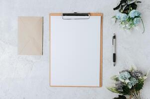 Note paper, letterhead and flowers placed on a white background. photo