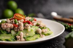 Stir fried zucchini with minced pork in white plate photo