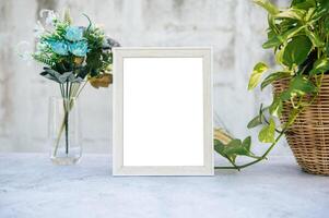 The picture frame is placed on the cement table. photo