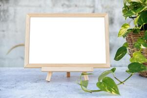 Picture frames placed on a cement table and small trees on the sides. photo