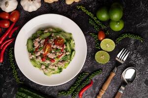 Stir fried zucchini with minced pork in white plate photo