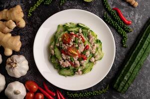 Stir fried zucchini with minced pork in white plate photo