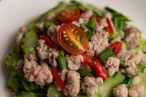 Stir fried zucchini with minced pork in white plate photo