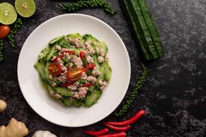 Stir fried zucchini with minced pork in white plate photo