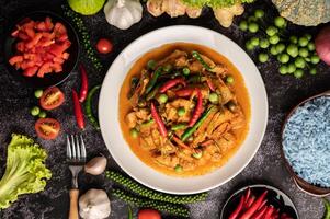 Red curry with pork in a white plate photo